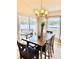 Bright dining room with a wooden table, chairs, and natural lighting from the sliding glass door at 8307 Glover Ave, North Port, FL 34291
