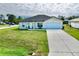 A beautiful home with a well-manicured lawn and a spacious driveway leading to the attached garage at 8307 Glover Ave, North Port, FL 34291