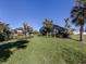 Landscaped backyard with tropical plants and a large lawn at 900 Osprey St, Venice, FL 34285