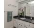 Bathroom with vanity, dark countertop, and a large mirror at 900 Osprey St, Venice, FL 34285