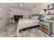 Bright bedroom with a queen bed, desk, and tiled floor at 900 Osprey St, Venice, FL 34285