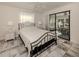 Bedroom with a queen bed, access to a screened porch, and tiled floor at 900 Osprey St, Venice, FL 34285