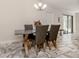 Bright dining room with a table and four chairs, featuring granite-top table and gray leather chairs at 900 Osprey St, Venice, FL 34285