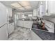 Kitchen with granite counters, white cabinets, and stainless steel appliances at 900 Osprey St, Venice, FL 34285