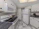 White kitchen with granite countertops, stainless steel appliances, and a microwave at 900 Osprey St, Venice, FL 34285