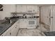 White kitchen with granite countertops and stainless steel appliances at 900 Osprey St, Venice, FL 34285