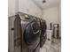 Laundry room with washer, dryer, cabinets, and tiled floor at 900 Osprey St, Venice, FL 34285