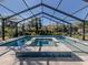 Relaxing pool and spa area with a screened enclosure at 900 Osprey St, Venice, FL 34285