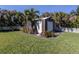 Yard with a storage shed and lush landscaping at 900 Osprey St, Venice, FL 34285
