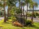 Landscaped median with a black metal fence and tropical plants at 900 Osprey St, Venice, FL 34285