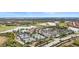 Aerial view of a luxurious community with a golf course, pool, and tennis courts at 10058 Crooked Creek Dr # 201, Venice, FL 34293