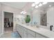 Double vanity bathroom with large mirror and walk-in shower at 10058 Crooked Creek Dr # 201, Venice, FL 34293