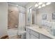 Clean bathroom with a shower/tub combo, vanity with quartz countertop and tile flooring at 10058 Crooked Creek Dr # 201, Venice, FL 34293