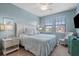 Spacious bedroom with a king-size bed, plenty of natural light and sitting area at 10058 Crooked Creek Dr # 201, Venice, FL 34293