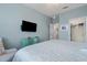 Main bedroom with a king bed, built-in TV and an ensuite bathroom at 10058 Crooked Creek Dr # 201, Venice, FL 34293