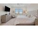 King-size bed, large TV, and ample dresser storage at 10058 Crooked Creek Dr # 201, Venice, FL 34293
