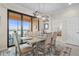 Bright dining room features a large table, access to a balcony, and a view at 10058 Crooked Creek Dr # 201, Venice, FL 34293