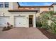 Inviting exterior featuring a two-car garage and well-manicured landscaping at 10058 Crooked Creek Dr # 201, Venice, FL 34293
