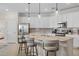Modern kitchen with white cabinets, island, and stainless steel appliances at 10058 Crooked Creek Dr # 201, Venice, FL 34293