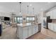 Modern kitchen with white cabinets, large island, and stainless steel appliances at 10058 Crooked Creek Dr # 201, Venice, FL 34293