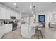 Modern kitchen with white cabinets, island with seating, and stainless steel appliances at 10058 Crooked Creek Dr # 201, Venice, FL 34293