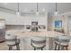 Modern kitchen with white cabinets, large island, and stainless steel appliances at 10058 Crooked Creek Dr # 201, Venice, FL 34293