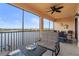 Screened lanai with lake view, comfortable seating, and outdoor dining area at 10058 Crooked Creek Dr # 201, Venice, FL 34293