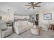 Open living space with white leather sofas and kitchen view at 10058 Crooked Creek Dr # 201, Venice, FL 34293