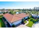 Aerial view of single-Gathering home with tile roof and canal views at 1008 Burning Oak Ct, Venice, FL 34293