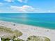 Drone view of beach with volleyball court and ocean at 1008 Burning Oak Ct, Venice, FL 34293