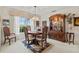 Bright dining room featuring a wooden table, hutch, and area rug at 1008 Burning Oak Ct, Venice, FL 34293