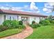 Front entrance with double doors, landscaping, and a brick walkway at 1008 Burning Oak Ct, Venice, FL 34293