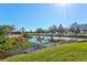 Peaceful waterfront view of a canal with lush vegetation at 1008 Burning Oak Ct, Venice, FL 34293