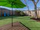 Relaxing backyard oasis with artificial turf, deck, hammock, and lush landscaping at 1041 Citrus Rd, Venice, FL 34293