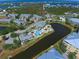 Aerial view of community, pool, and waterfront at 10501 Amberjack Way # 103, Englewood, FL 34224