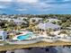 Aerial view of community pool and residential buildings at 10501 Amberjack Way # 103, Englewood, FL 34224