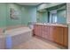 Spa-like bathroom featuring double sinks and a large soaking tub at 10501 Amberjack Way # 103, Englewood, FL 34224
