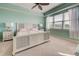 Bright bedroom featuring a ceiling fan and large windows at 10501 Amberjack Way # 103, Englewood, FL 34224