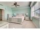 Spacious bedroom with ceiling fan, large windows, and carpeted floors at 10501 Amberjack Way # 103, Englewood, FL 34224