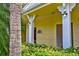 Building entrance with landscaping and columns at 10501 Amberjack Way # 103, Englewood, FL 34224