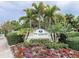 The Hammocks community entrance with lush landscaping at 10501 Amberjack Way # 103, Englewood, FL 34224