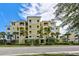 Building exterior with palm trees and landscaping at 10501 Amberjack Way # 103, Englewood, FL 34224