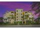Beautiful yellow building exterior with palm trees at 10501 Amberjack Way # 103, Englewood, FL 34224