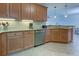 Modern kitchen with granite countertops and stainless steel appliances at 10501 Amberjack Way # 103, Englewood, FL 34224