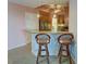 Kitchen boasts granite countertops and breakfast bar with two stools at 10501 Amberjack Way # 103, Englewood, FL 34224