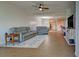 Spacious living room featuring comfy grey sofas and a wood-look floor at 10501 Amberjack Way # 103, Englewood, FL 34224
