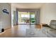 Bright living room with tile floors, access to a screened balcony, and coastal decor at 10501 Amberjack Way # 103, Englewood, FL 34224