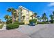 Parking area with landscaping and building view at 10501 Amberjack Way # 103, Englewood, FL 34224