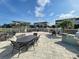 Community patio with grills and tables for outdoor dining at 10501 Amberjack Way # 103, Englewood, FL 34224