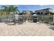 Community patio with grill and seating overlooking a pond at 10501 Amberjack Way # 103, Englewood, FL 34224